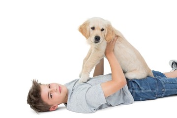 Sticker - Boy holding puppy while lying over white background