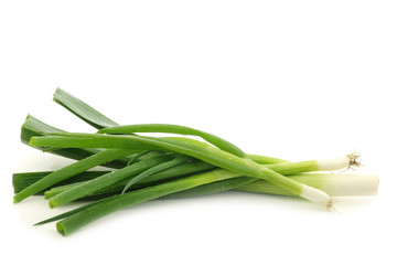 Wall Mural - Fresh cut leek and spring onions on a white background