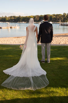 looking at at the lake bride groom back dress