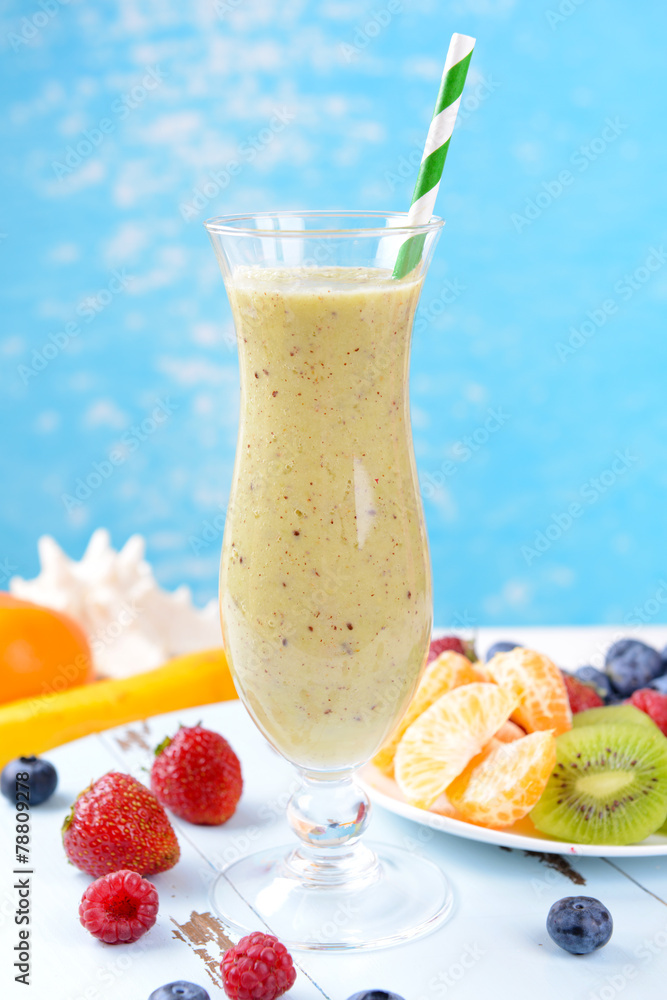 Delicious berry cocktail on table on water background