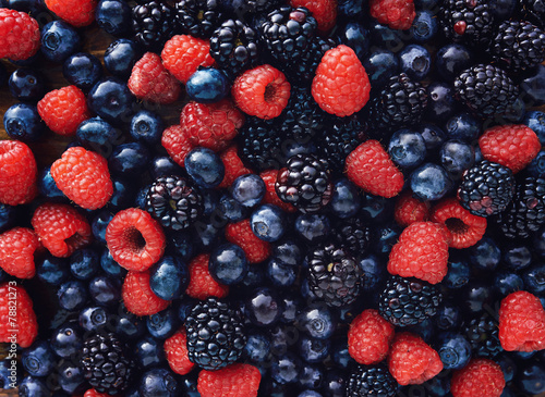 Fototapeta na wymiar blueberies, raspberries and black berries shot top down