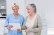 © WavebreakmediaMicro - Nurse and senior patient discussing over clipboard