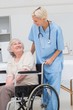 © WavebreakmediaMicro - Nurse looking at senior patient sitting on wheelchair