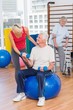 © WavebreakmediaMicro - Trainer assisting senior man in lifting dumbbells