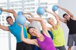 © WavebreakmediaMicro - Instructor with class exercising with fitness balls