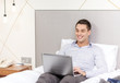 © Syda Productions - happy businesswoman with laptop in hotel room