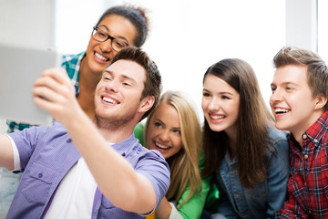 Wall Mural - students taking selfie with tablet pc at school