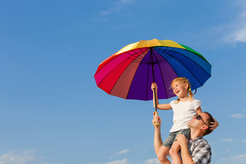 Dad and daughter playing near a house