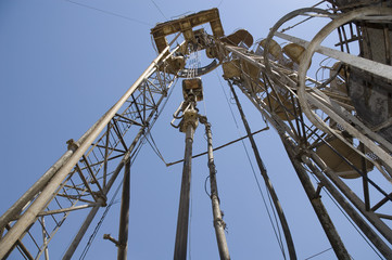 Wall Mural - Old drilling rig against the blue sky