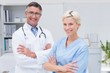 © WavebreakmediaMicro - Nurse and doctor standing arms crossed at clinic