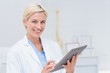 © WavebreakmediaMicro - Confident female doctor using digital tablet