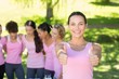 © WavebreakMediaMicro - Smiling women in pink for breast cancer awareness