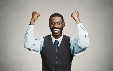 Successful businessman celebrates victory grey background 