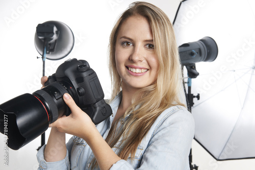Naklejka ścienna Female Professional Photographer Working In Studio