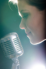 Wall Mural - Closeup of beautiful woman with microphone