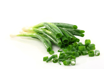 Wall Mural - Fresh cut leek and spring onions on a white background