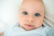 © Marko Balenovic - Beautiful baby with gorgeous blue eyes lying on his back in bed