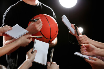 Wall Mural - Autographs by basketball star on black and lights background