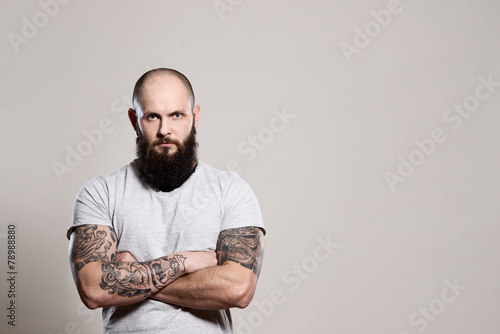 Bearded man with crossed arms