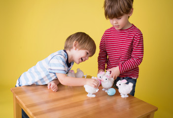 Wall Mural - Kids playing with Easter Bunny Toys