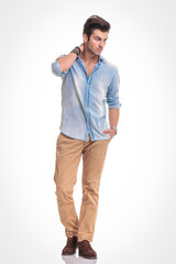 Wall Mural - Attractive fashion man walking on studio background