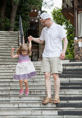 Beautiful little girl playing with her father