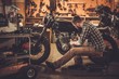 © Nejron Photo - Mechanic building vintage style cafe-racer motorcycle