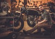 © Nejron Photo - Mechanic building vintage style cafe-racer motorcycle