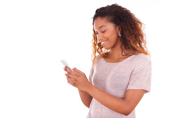 African American young woman sending a text message on her smart