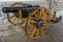 Old Medieval Artillery Canon Before A Stone Wall