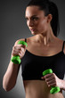 © chettythomas - Fitness woman working out with green dumbbell