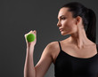 © chettythomas - Fitness woman working out with green dumbbell