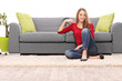 © Ljupco Smokovski - Beautiful woman sitting by a sofa on the floor