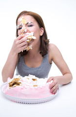 Wall Mural - Cute woman sitting at the table and eating cake