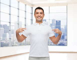 Canvas Print - smiling man in t-shirt pointing fingers on himself