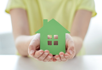 Poster - close up of happy girl hands holding paper house