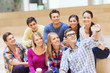© Syda Productions - group of students with smartphone and coffee cup