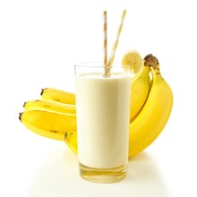 Banana Smoothie In A Glass With Straws Over White