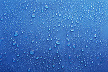 Water Drops On Glass On Blue Background