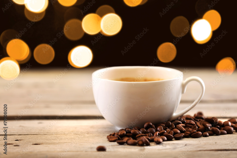 Cup of coffee on table on brown background