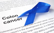 Paper with colon cancer and dark blue ribbon.