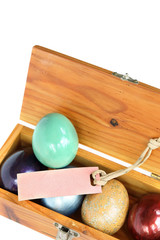 Wall Mural - Colorful easter eggs in wood box on white background with paper