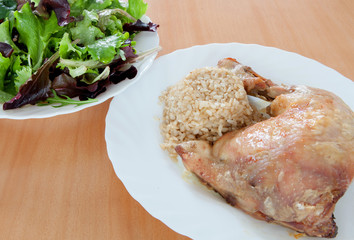 Roasted chicken with rice and salad.