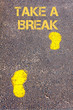 Yellow footsteps on sidewalk towards Take a break message