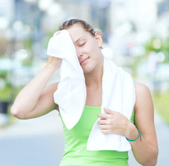  Tired woman after fitness time and exercising in city street par
