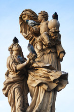 Statue On The Charles Bridge In Prague With Pigeons