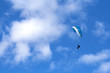 Paragliding in the blue sky with skis