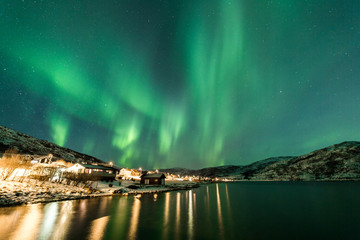Wall Mural - northern lights over village in norway coast