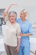 © WavebreakmediaMicro - Nurse assisting senior patient in raising arm