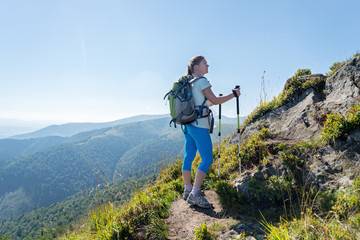 Wall Mural - young woman hiking in the mountains